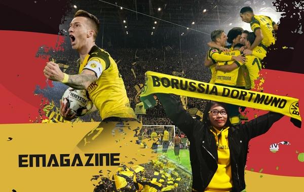 Hình ảnh khán đài chật kín khán giả với cờ và biểu ngữ tại một trận đấu Bundesliga, thể hiện sự cuồng nhiệt và sức mạnh tinh thần mà cổ động viên mang lại cho các đội bóng Đức.